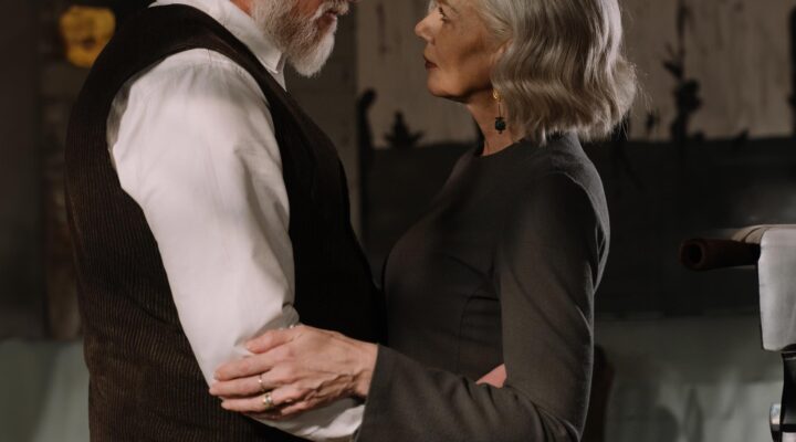 Older male escort and woman looking at each other