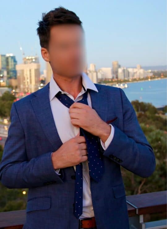 Jack 7 Male Escort for Women in Perth Jack dressed in blue suit undoing tie