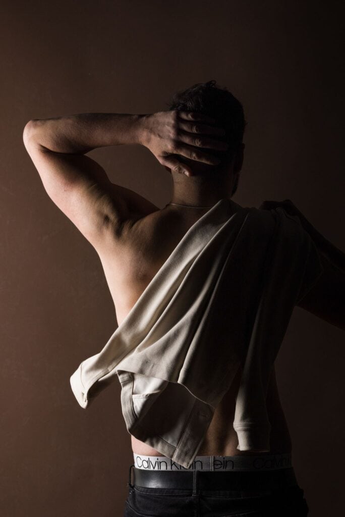 Attractive man shirtless touching his head
