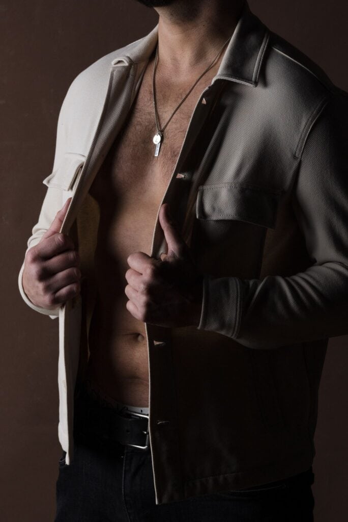 Male model in open shirt touching his shirt